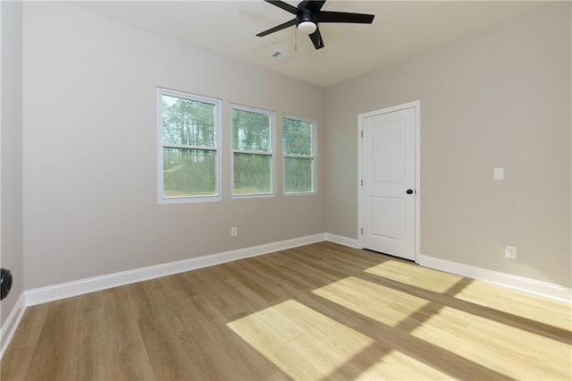 empty room featuring hardwood / wood-style floors and ceiling fan