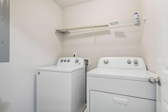 washroom with separate washer and dryer and electric panel