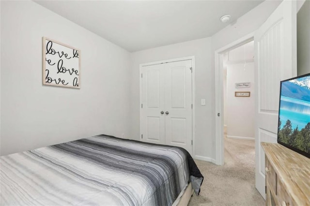 bedroom featuring a closet and light carpet