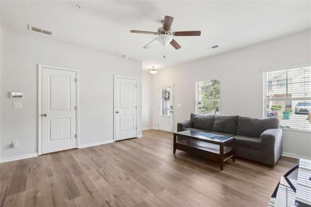 living room featuring hardwood / wood-style flooring and ceiling fan