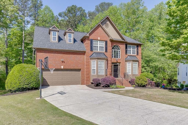 view of front of property featuring brick siding, driveway, a front yard, a garage, and roof with shingles