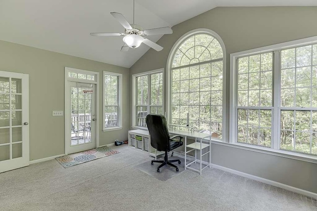 carpeted office space with vaulted ceiling, baseboards, and plenty of natural light