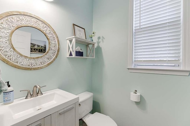 bathroom featuring toilet and vanity