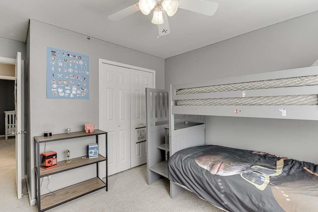 carpeted bedroom featuring a ceiling fan and a closet