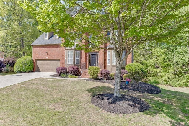 view of property hidden behind natural elements featuring brick siding, an attached garage, a front lawn, and concrete driveway