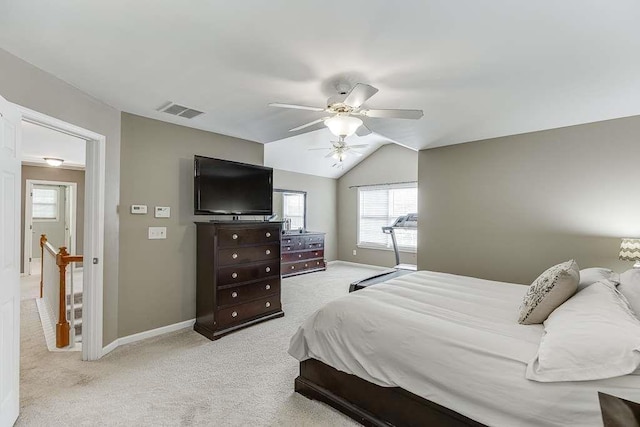 bedroom with vaulted ceiling, ceiling fan, light carpet, baseboards, and visible vents