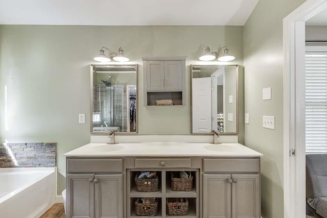 full bathroom with a garden tub, a sink, and double vanity