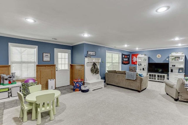 carpeted living area with wainscoting, recessed lighting, and crown molding