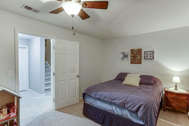 carpeted bedroom featuring visible vents and a ceiling fan