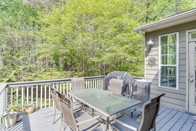 wooden deck featuring outdoor dining area