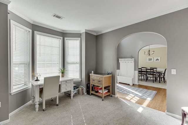 office featuring an inviting chandelier, visible vents, arched walkways, and ornamental molding