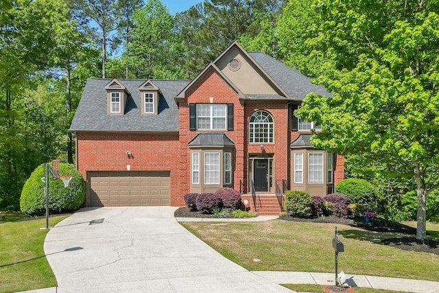 view of front facade featuring concrete driveway, brick siding, a front yard, and a garage
