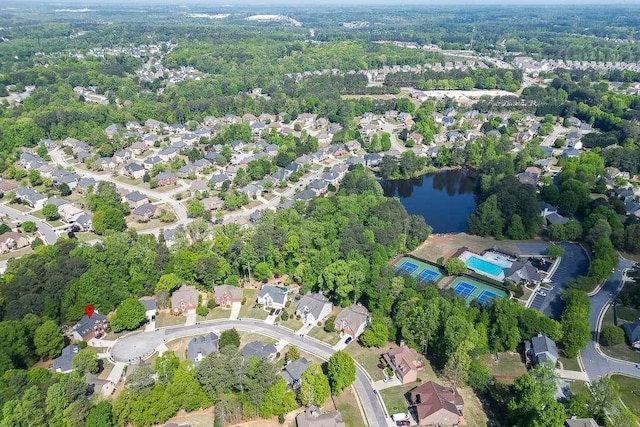 bird's eye view featuring a forest view and a water view