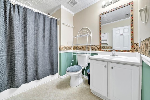 bathroom featuring vanity, toilet, ornamental molding, a textured ceiling, and curtained shower