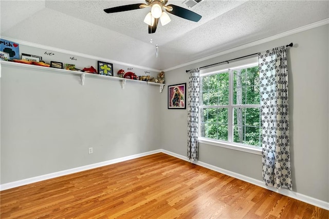 empty room featuring ceiling fan, plenty of natural light, a textured ceiling, and light hardwood / wood-style flooring