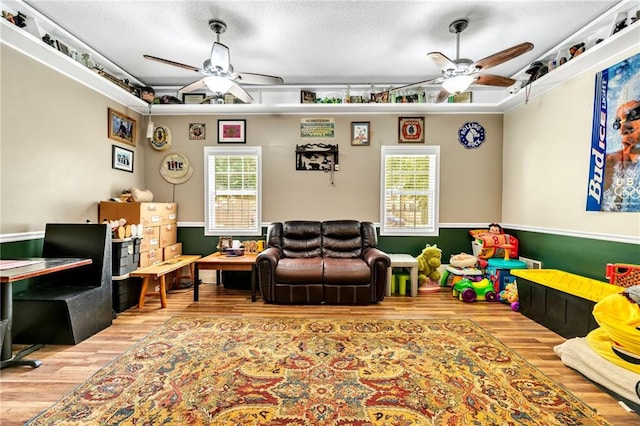 playroom with hardwood / wood-style floors, a wealth of natural light, and ceiling fan