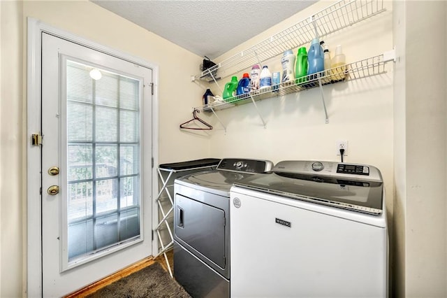 laundry area featuring independent washer and dryer and a textured ceiling