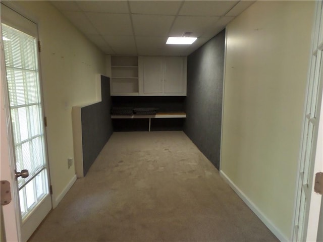 interior space with light carpet and a drop ceiling