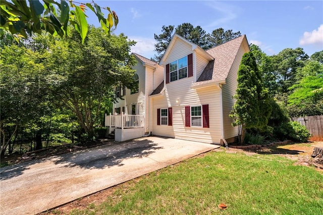 rear view of property featuring a yard and a patio area