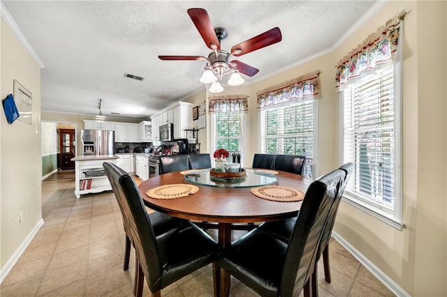 dining area featuring a textured ceiling, ceiling fan, crown molding, and a wealth of natural light