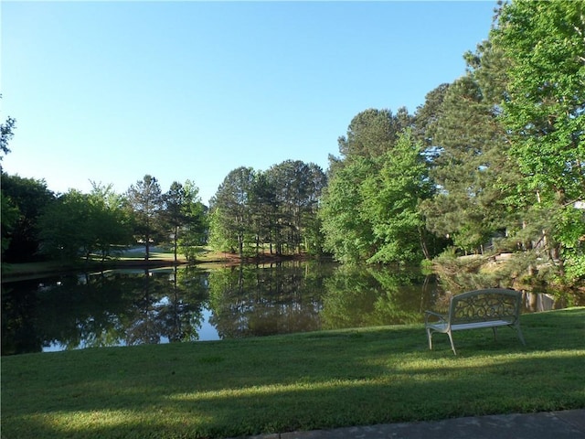 surrounding community with a lawn and a water view