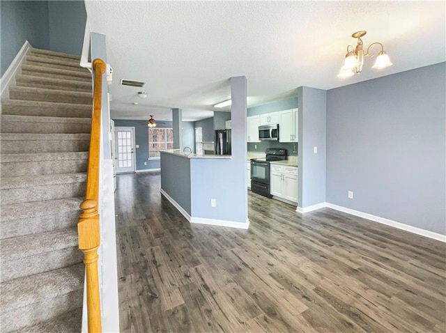 453 Inkberry Dr, Atlanta, GA 30349 - kitchen featuring a textured ceiling, black appliances, ceiling fan with notable chandelier, white cabinetry, and dark hardwood / wood-style floors
