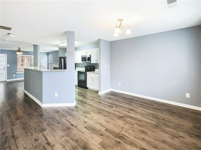 453 Inkberry Dr, Atlanta, GA 30349 - kitchen with hanging light fixtures, ceiling fan with notable chandelier, white cabinets, black appliances, and dark hardwood / wood-style flooring