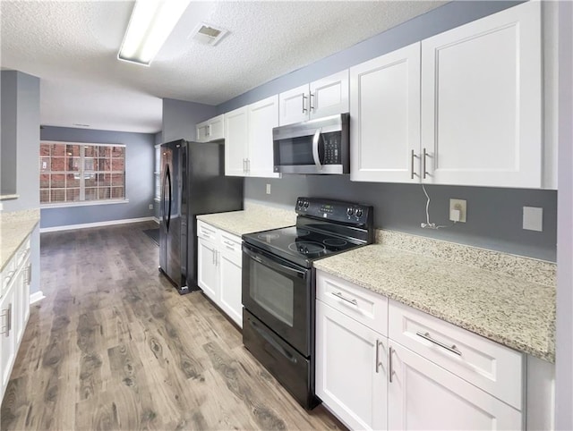 453 Inkberry Dr, Atlanta, GA 30349 - kitchen featuring white cabinets, a textured ceiling, and black appliances