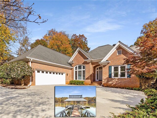 view of front of property with a garage and a water view