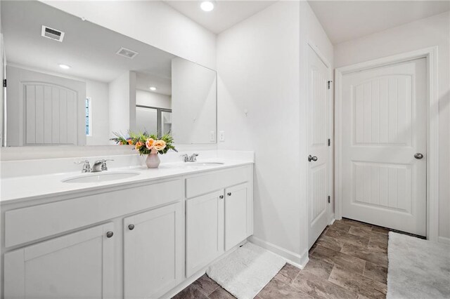 174 Sienna Blf, Dallas, GA 30132 - bathroom featuring double vanity, visible vents, and a sink