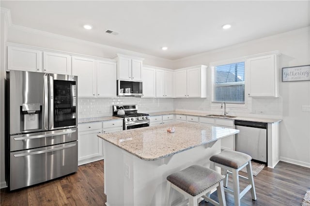 174 Sienna Blf, Dallas, GA 30132 - kitchen with white cabinetry, stainless steel appliances, dark wood-type flooring, a kitchen island, and a sink