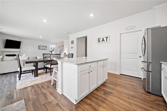 174 Sienna Blf, Dallas, GA 30132 - kitchen with freestanding refrigerator, white cabinetry, dark wood-style floors, and a center island