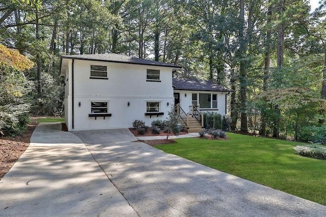 1770 Austin Dr, Decatur, GA 30032 - tri-level home featuring a front lawn, view of scattered trees, and driveway