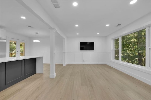 1770 Austin Dr, Decatur, GA 30032 - unfurnished living room featuring light wood finished floors, recessed lighting, a wainscoted wall, and a decorative wall