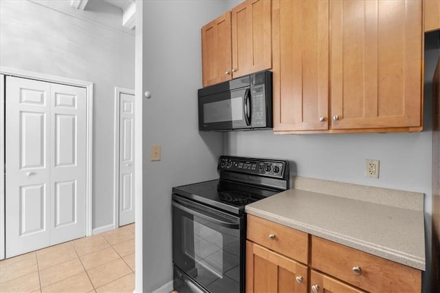 kitchen featuring light tile patterned floors and black appliances