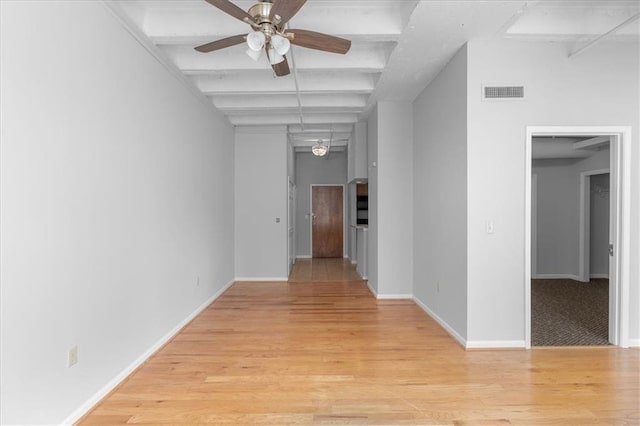 hallway with beam ceiling and light hardwood / wood-style flooring