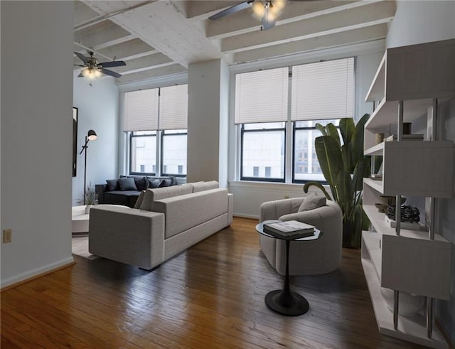 living room featuring beamed ceiling, dark hardwood / wood-style floors, and ceiling fan