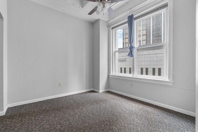 spare room featuring ceiling fan and carpet