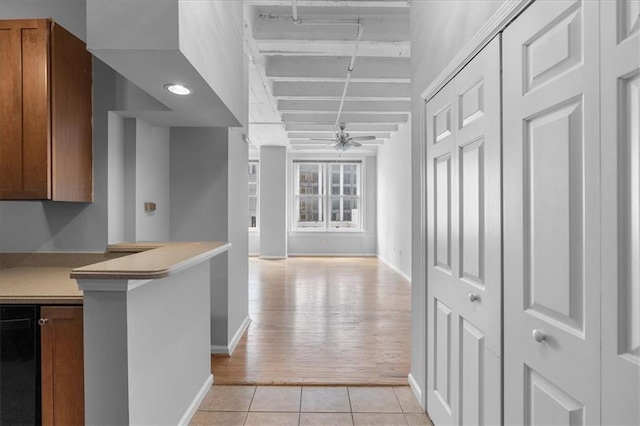 kitchen with ceiling fan, kitchen peninsula, and light tile patterned floors