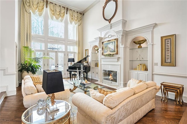 1500 Historic Vw, Stone Mountain, GA 30087 - living room with a towering ceiling, wood finished floors, a fireplace with flush hearth, ornamental molding, and built in shelves