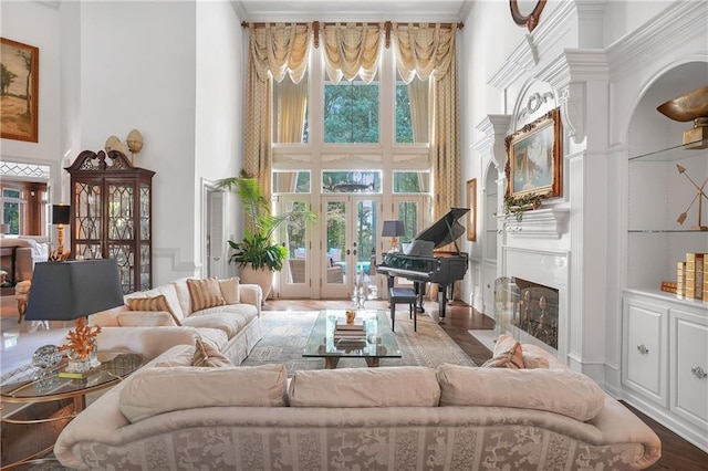 1500 Historic Vw, Stone Mountain, GA 30087 - living room with a towering ceiling, a fireplace with flush hearth, french doors, arched walkways, and wood finished floors