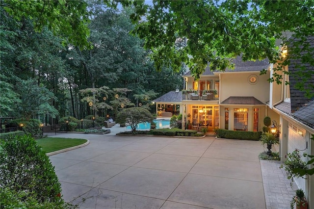 1500 Historic Vw, Stone Mountain, GA 30087 - view of front of house with a balcony, stucco siding, a patio area, an outdoor pool, and concrete driveway