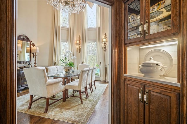 1500 Historic Vw, Stone Mountain, GA 30087 - dining area with a chandelier, healthy amount of natural light, a towering ceiling, and wood finished floors
