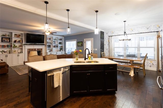 kitchen with a sink, open floor plan, stainless steel dishwasher, and light countertops