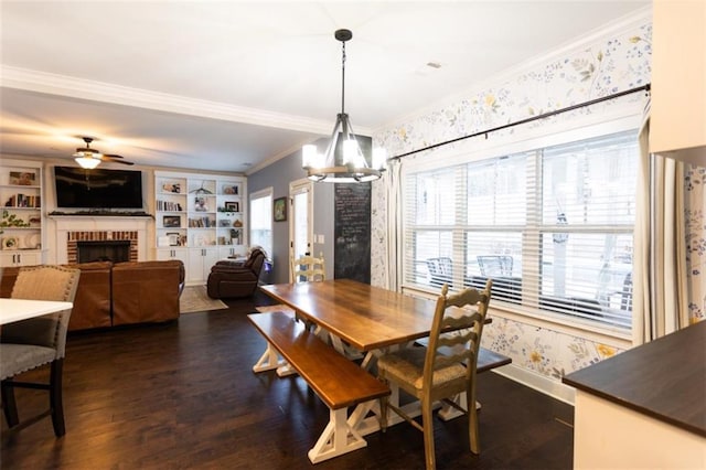 dining room featuring dark wood-style floors, ornamental molding, a brick fireplace, baseboards, and wallpapered walls