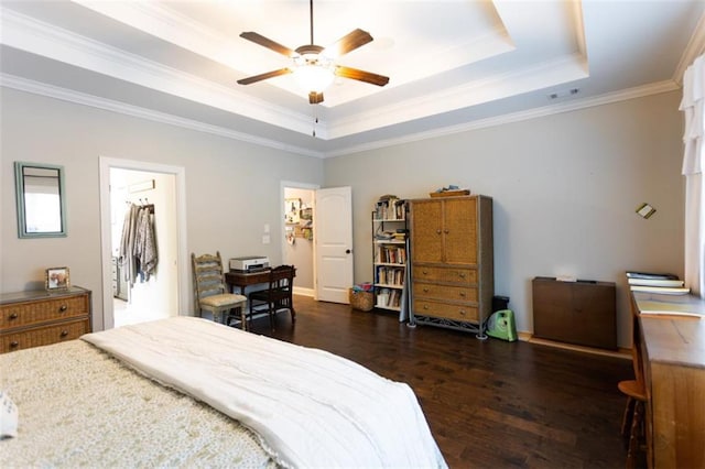 bedroom with ceiling fan, visible vents, ornamental molding, dark wood-style floors, and a tray ceiling