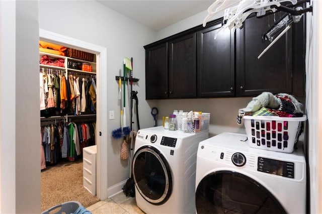 clothes washing area with cabinet space, baseboards, and washer and dryer