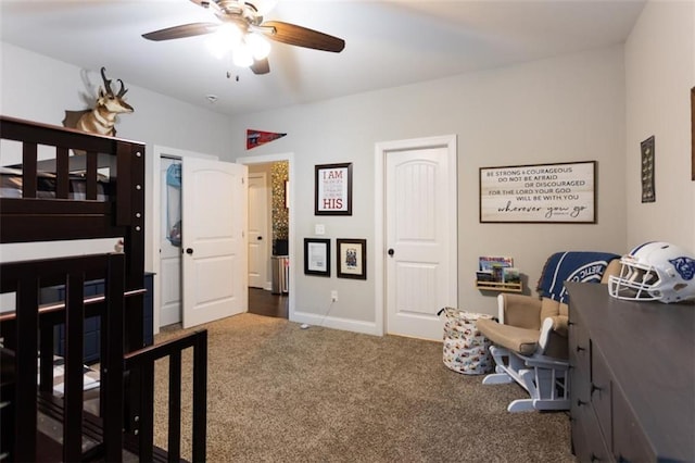 carpeted bedroom with ceiling fan and baseboards