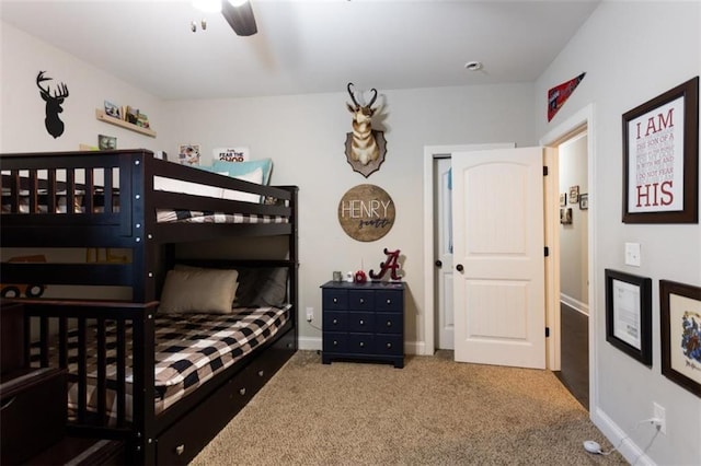 carpeted bedroom featuring ceiling fan and baseboards