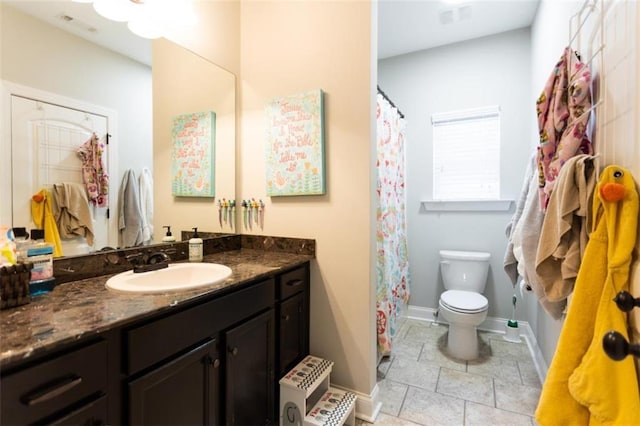 bathroom with baseboards, visible vents, vanity, and toilet